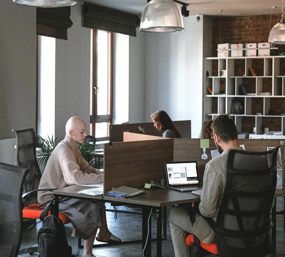 Partner with Braven Foundation working in a spacious, open office, emphasizing partnership and a dynamic work atmosphere.