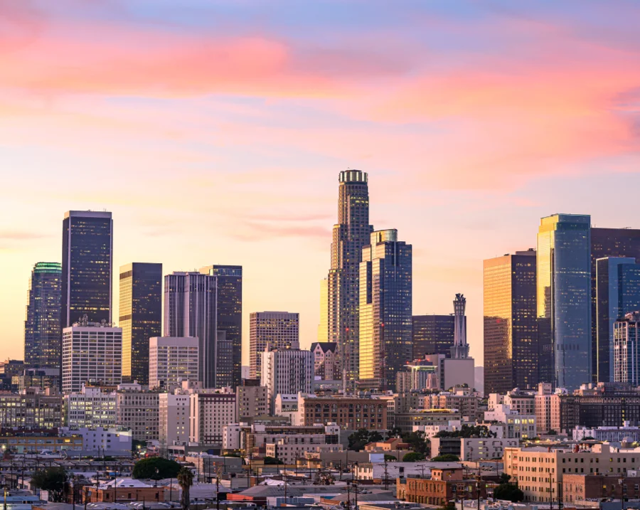 A stunning sunset casts vibrant colors over the Los Angeles skyline, symbolizing growth and opportunity through the LA Optimized Small Business Growth Program